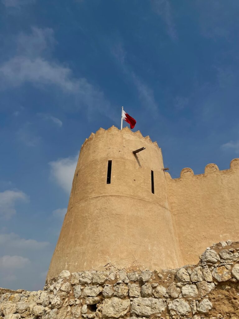 a tall tower with a flag on top of it