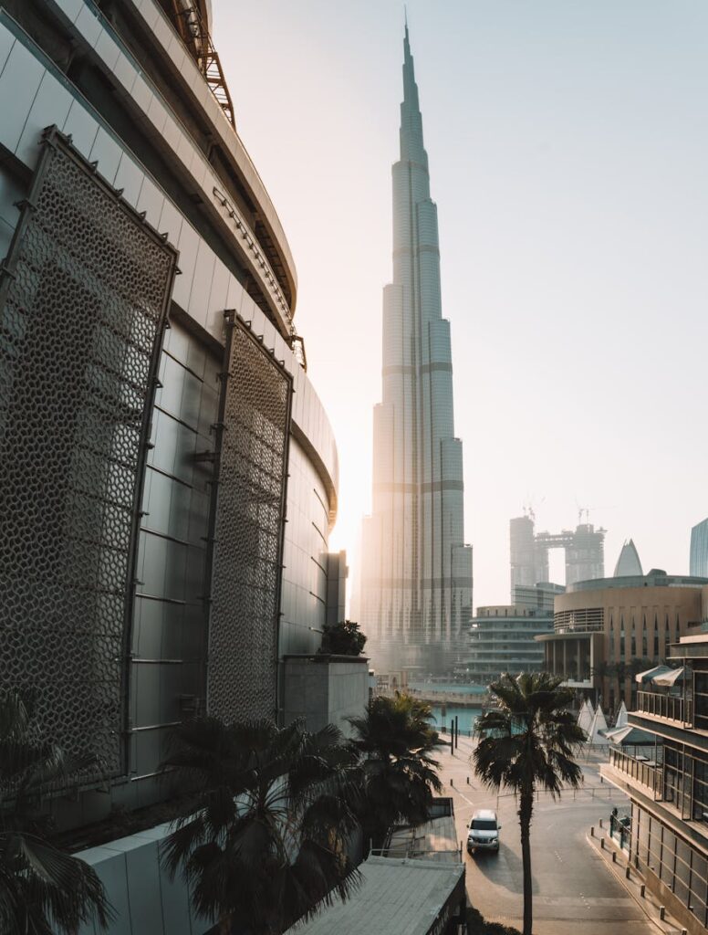 A breathtaking morning view of Burj Khalifa in Dubai with modern architecture and palm trees.